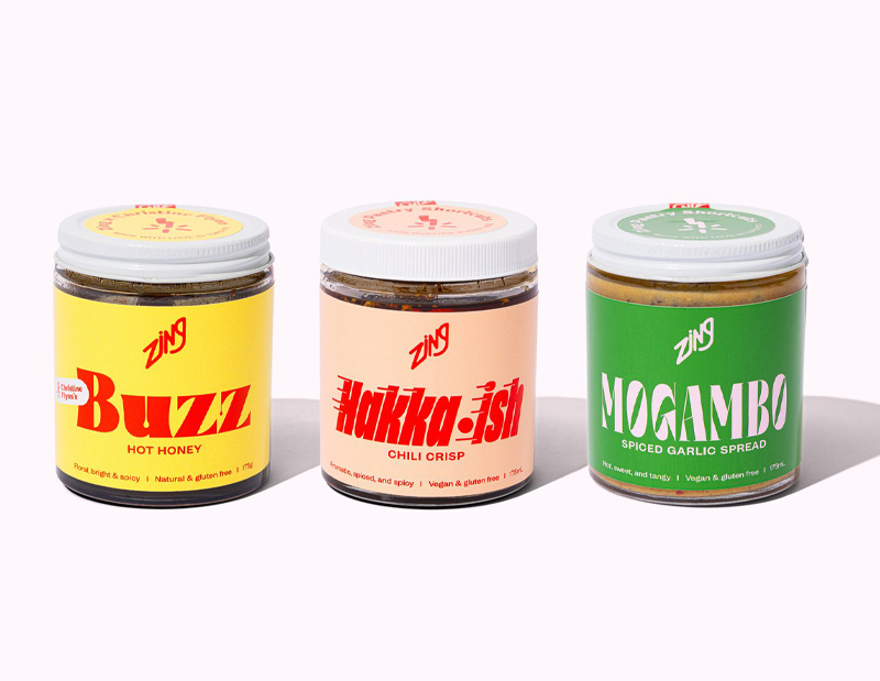 A photo of three Zing product jars with bright colour packaging 