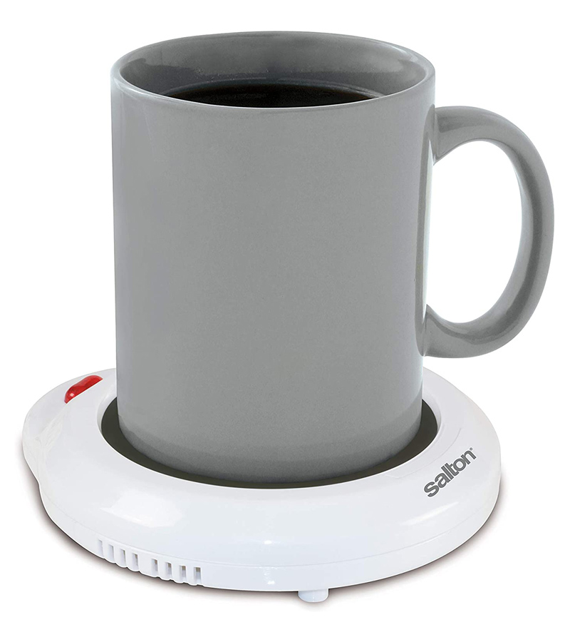 A grey mug sitting on a white electric mug warmer 