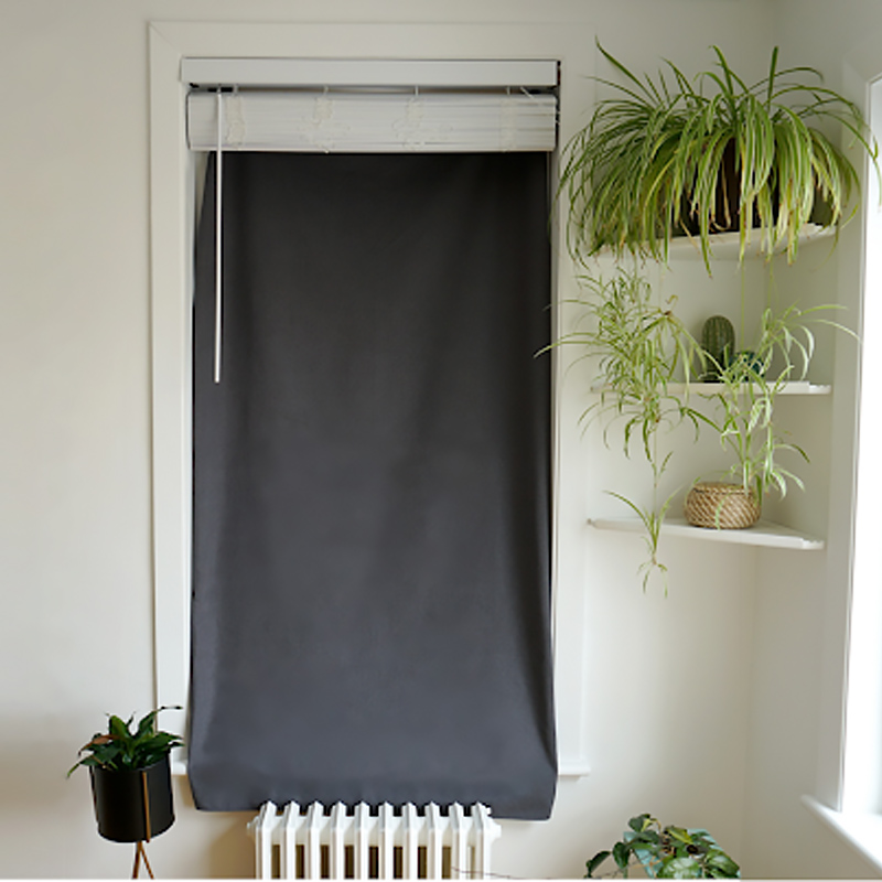 Long blackout curtains against a window 