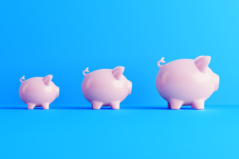 An image of three pink piggy banks lined up in a row