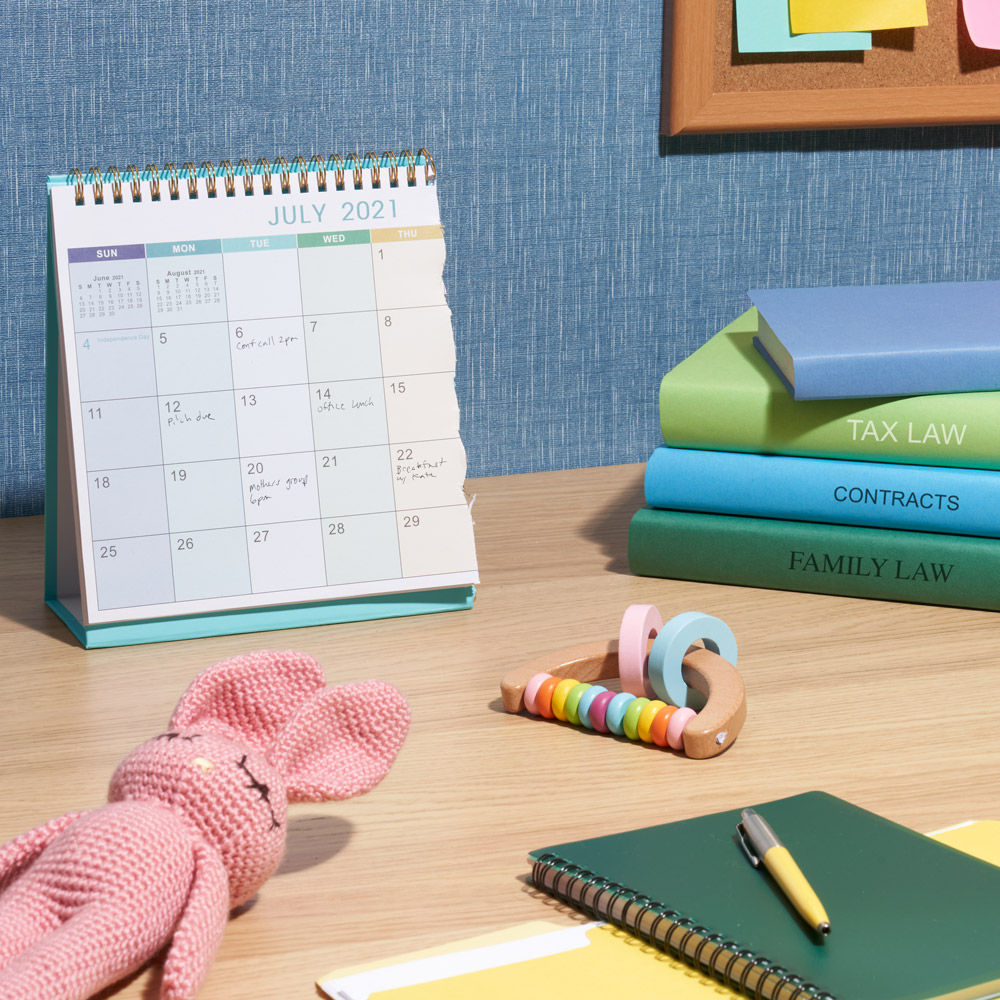 A photo of a desk with office supplies and baby toys on top