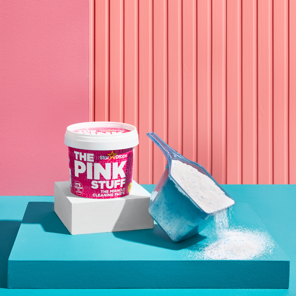 A photo of The Pink Stuff cleaning paste and Tide laundry detergent 