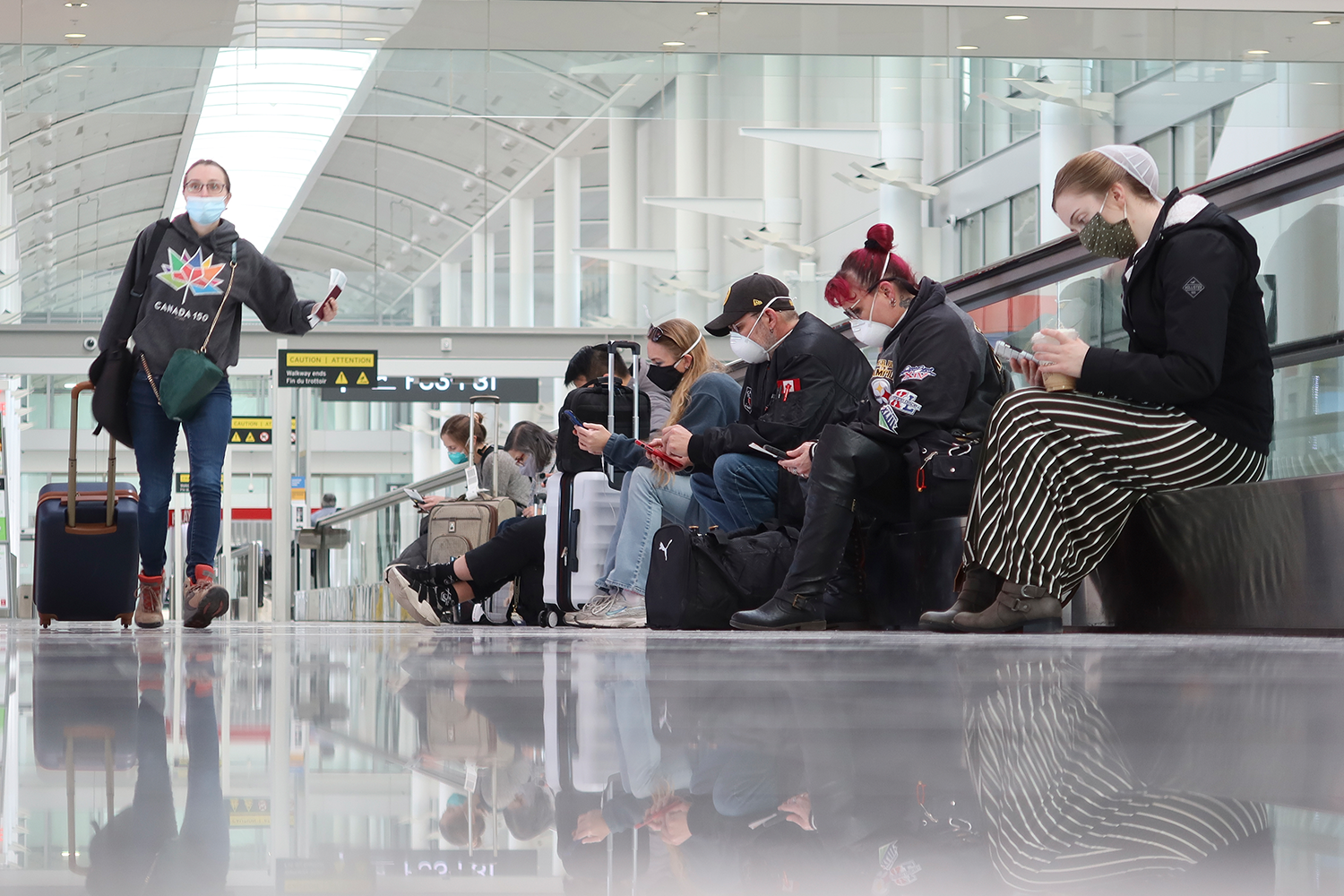 A photo of travellers waiting for their flights at Toronto Pearson airport