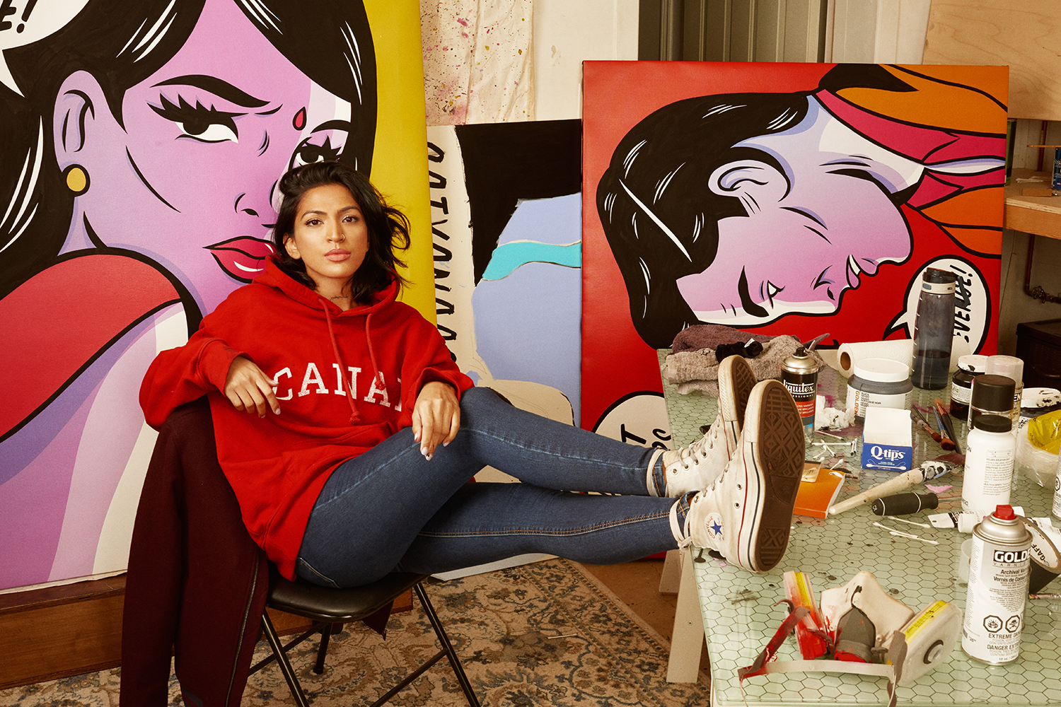 A photo of Maria Qamar, known as Hatecopy, with her artwork