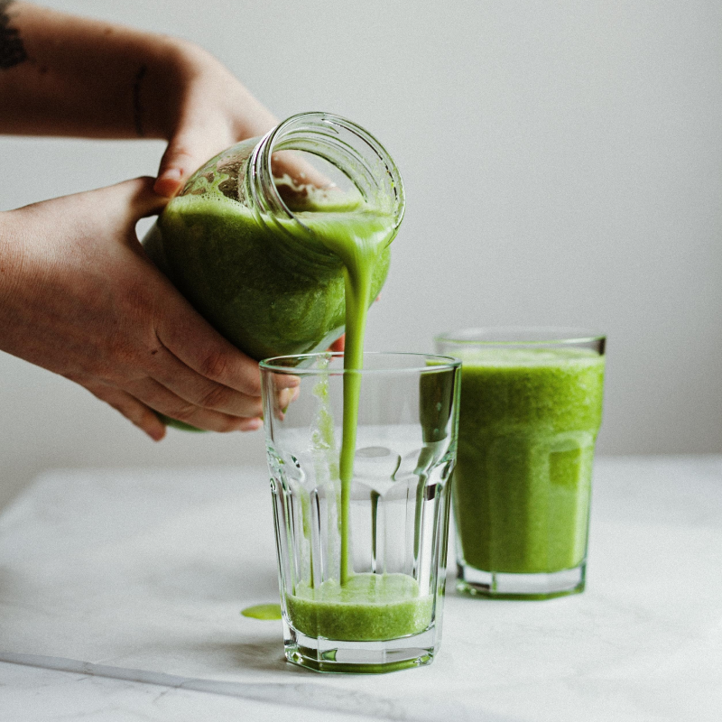 A photo of green juice in a glass