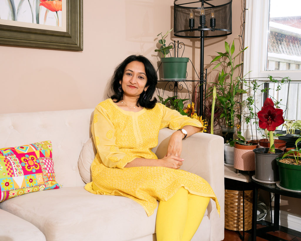 Madhavi Kulkarni sitting in her living room 
