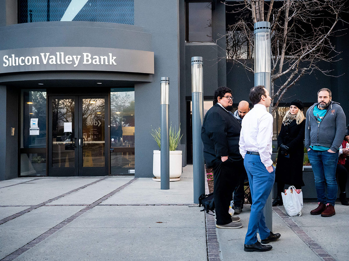 People standing outside of an SVB branch after its collapse