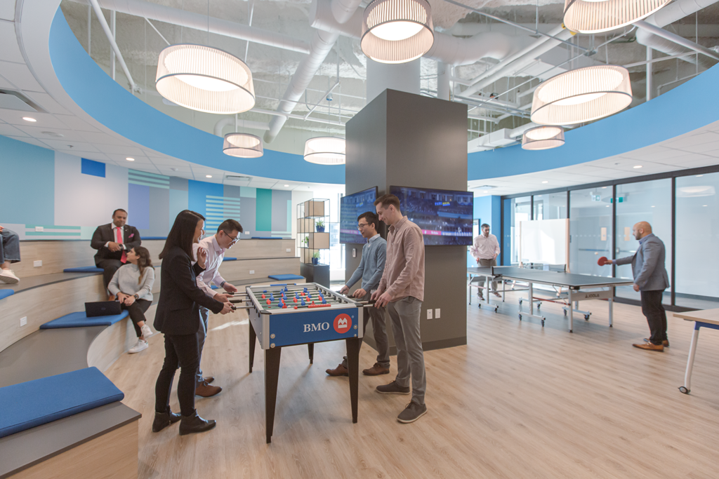 A foosball table inside BMO Toronto's office with workers playing