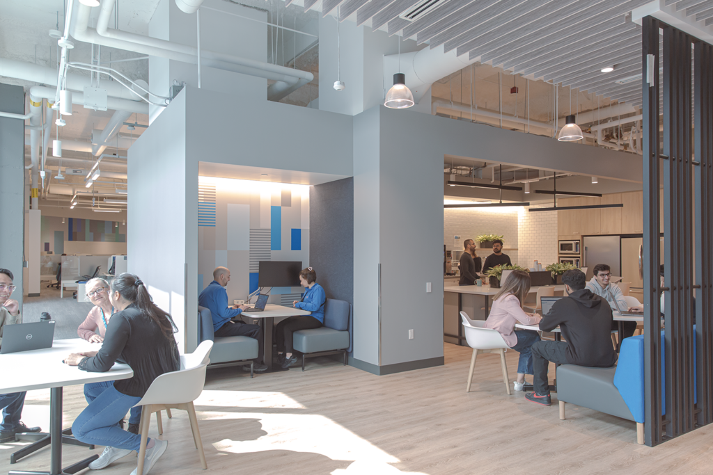A cafe and seated area in BMO Toronto's office with workers sitting down and eating and working 