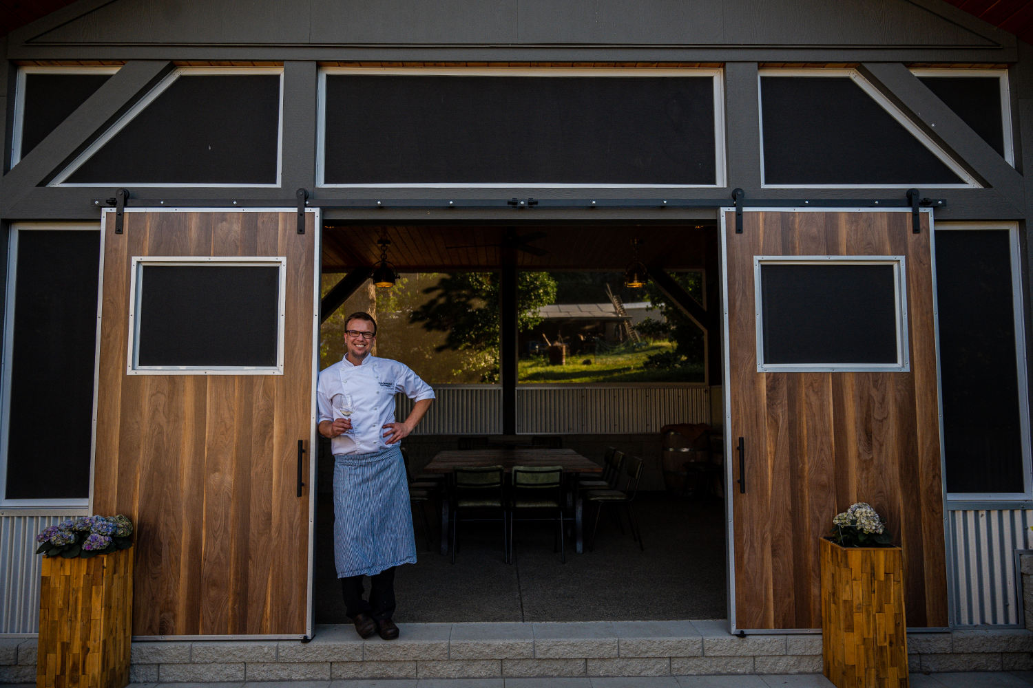 Chef Chris Van Hooydonk standing outside Chef's Table restaurant