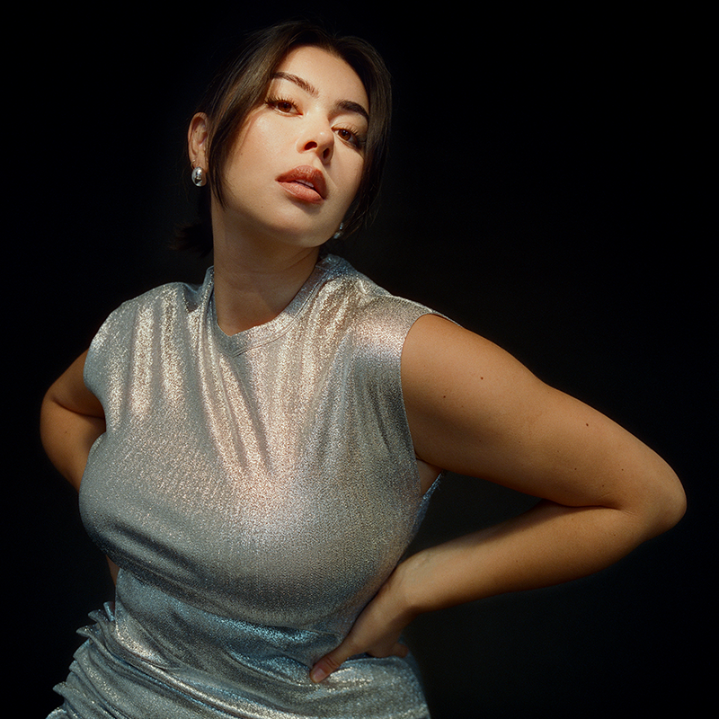 Model Lauren Chan posing in a silver dress