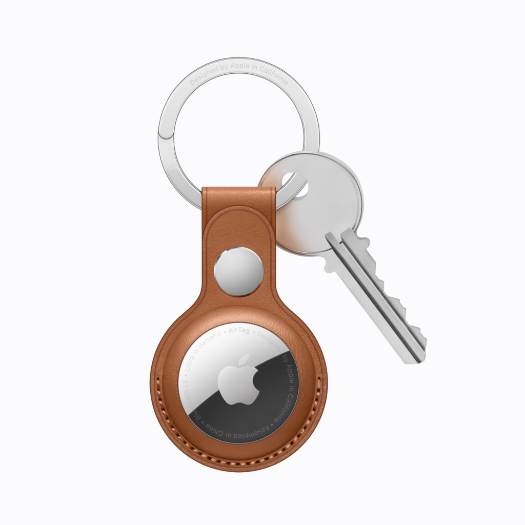 An Apple AirTag with a key holder attached to it