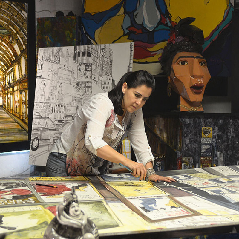 A photo of artist Karla de Lara working on artwork 