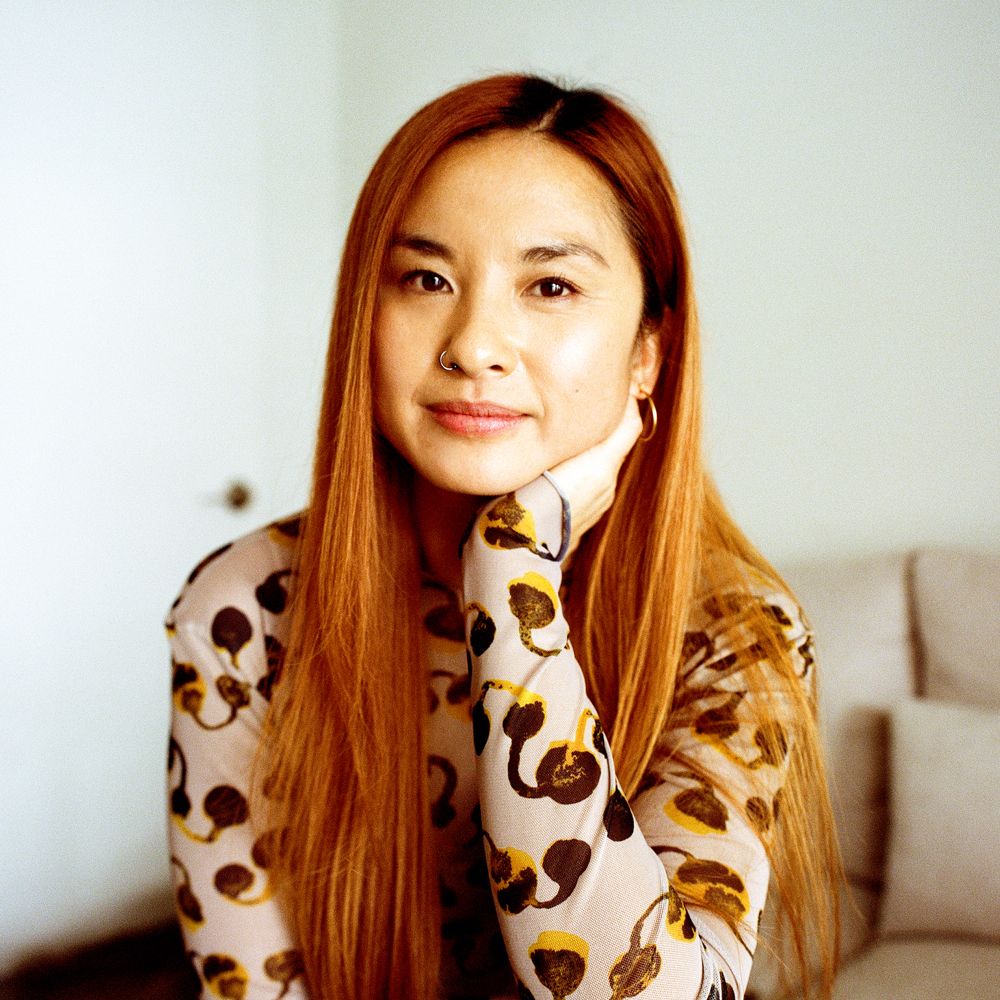 Ruru Baked founder Luanne Ronquillo sitting with her hand against her chin wearing a printed top