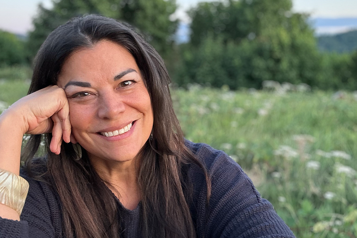 Patrice Mousseau, founder of Satya Organics, smiling in a grassy field