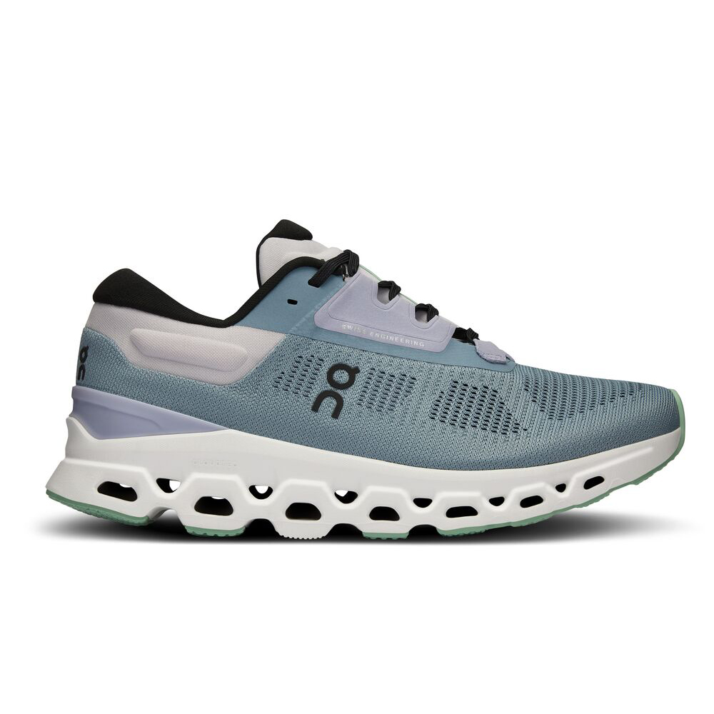 A teal sneaker with a white sole with holes on a white background