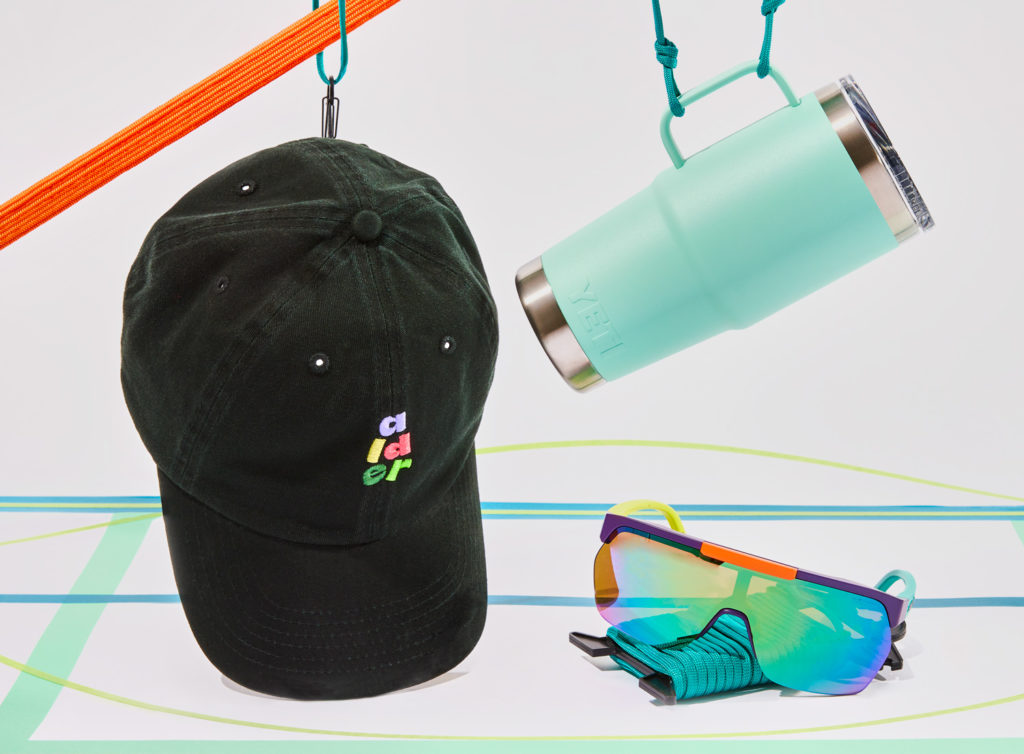 A ball cap, insulated mug and sunglasses